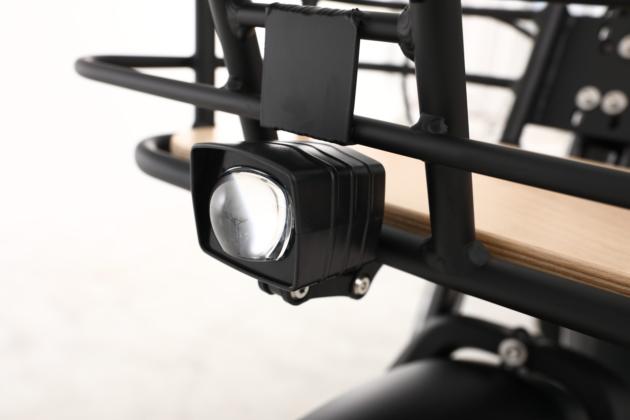Close-up of a black spotlight attached to a cargo tricycle rack. Perfect for adult tricycles and electric tricycles in Australia.