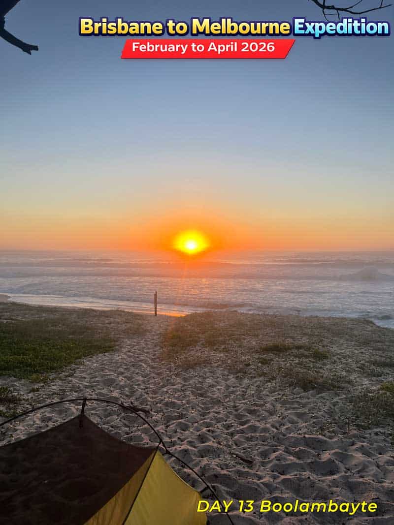 Sunset on a sandy beach path in Australia. A serene scene with the sun setting over the ocean.