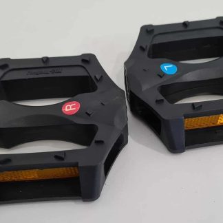 A pair of black bicycle pedals with reflective orange strips and red and blue reflectors on a plain white background.