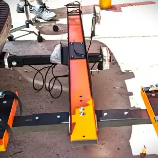 Custom-built trike frame with orange and black components for adult tricycles.