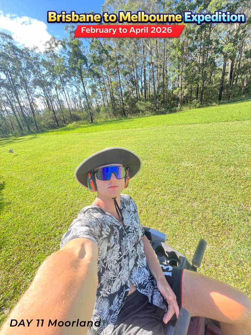 Man on a tricycle wearing a hat and sunglasses