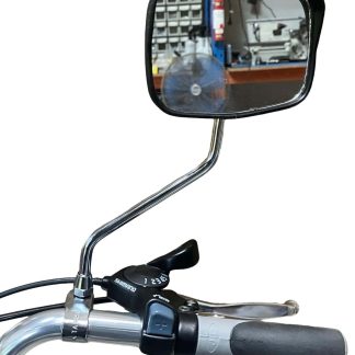 A close-up of a tricycle's rear view mirror. The mirror is attached to a metal stem.