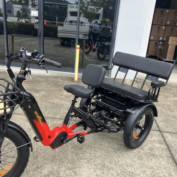 Red and Black Electric Tricycle for Adults Electric tricycle with red and black frame and two seats. Ideal for seniors and disability mobility.