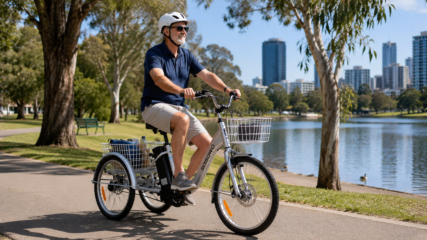 Man riding silver electric adult tricycle on a park path. Ideal for seniors and disability mobility in Australian environments.