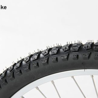 Close-up of a black tyre with silver spokes on a white rim.